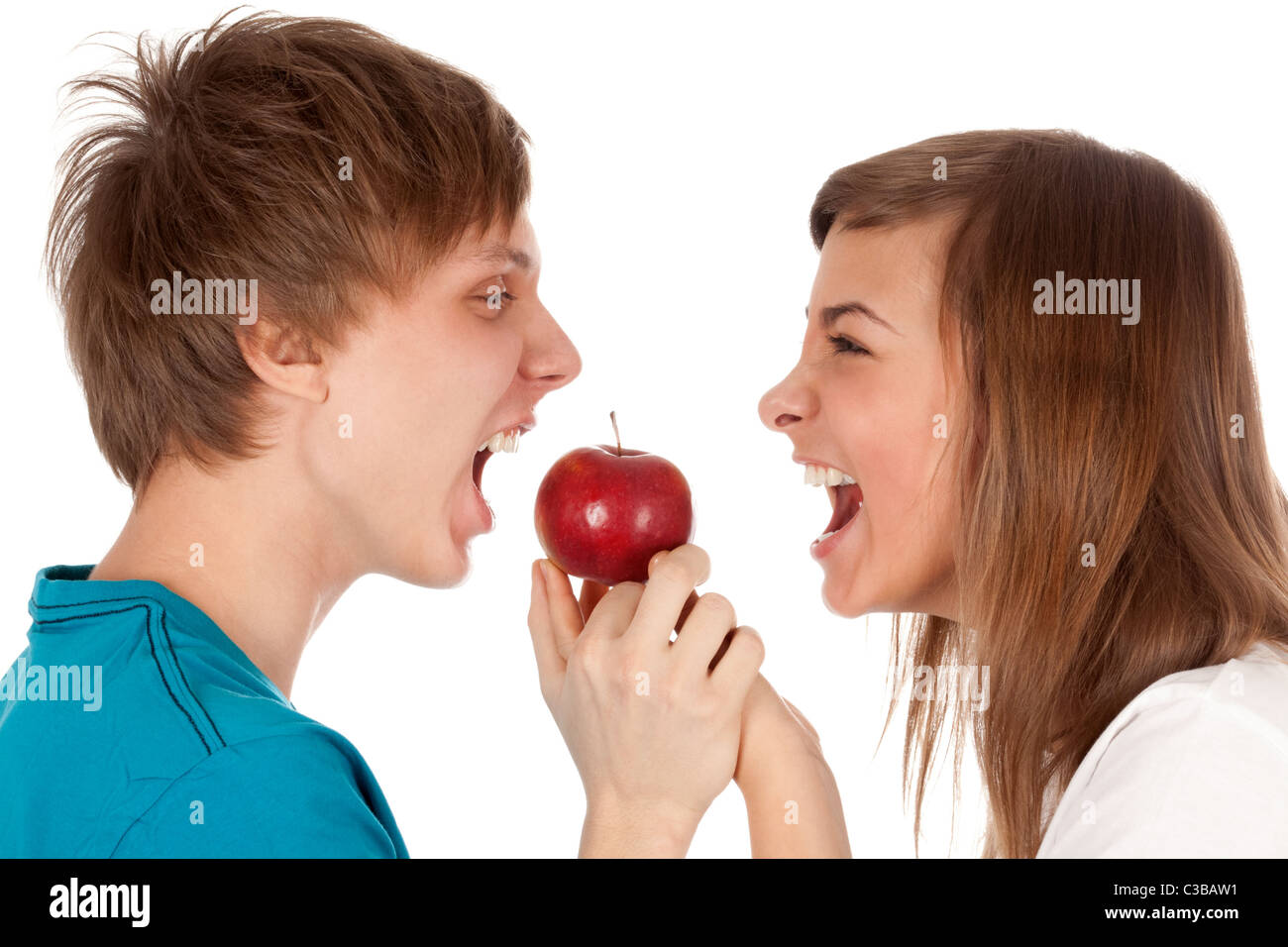 boy and a girl biting the apple on a white background Stock Photo