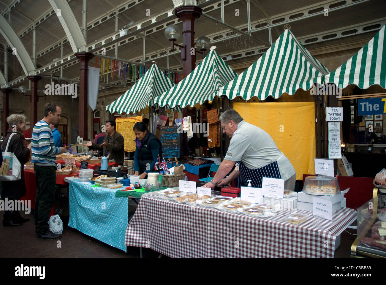 Stall holders selling fresh produce at Bath Farmers Market, Green Park