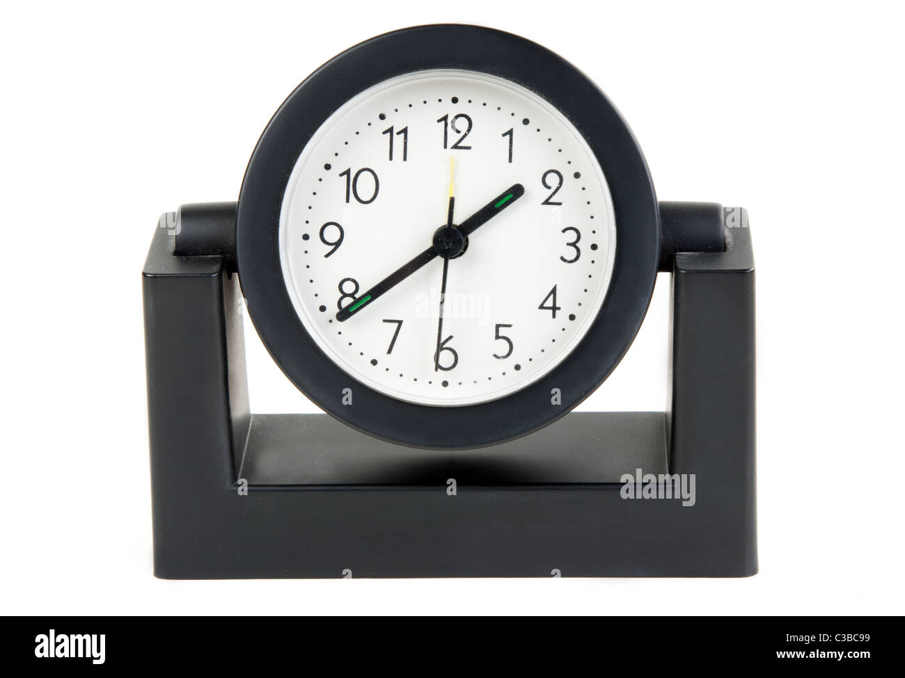 Desktops mechanical clock in a black plastic casing with a white background Stock Photo