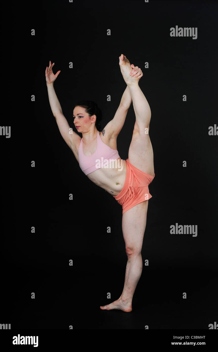 Young female modern dancer On black Background Stock Photo