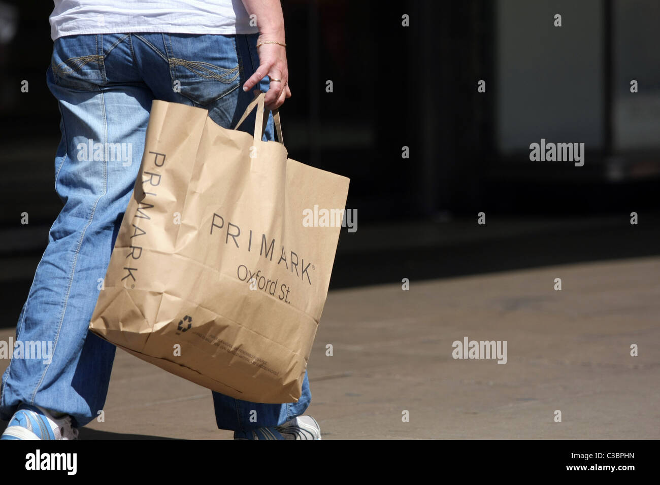 Part of a person carrying a Primark shopping bag in Oxford Street ...