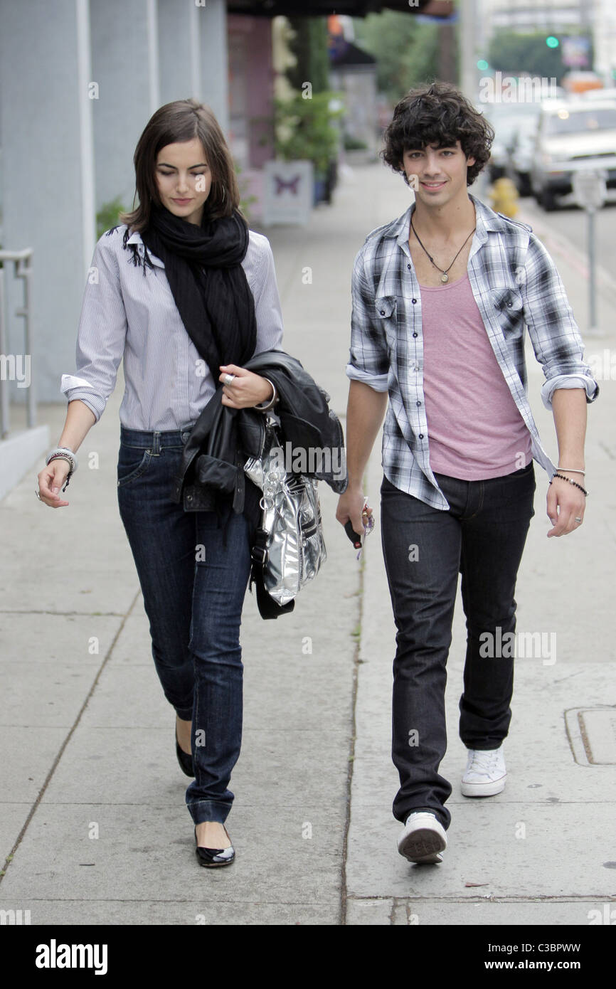 Joe Jonas of the Jonas Brothers and Camilla Belle walking down the