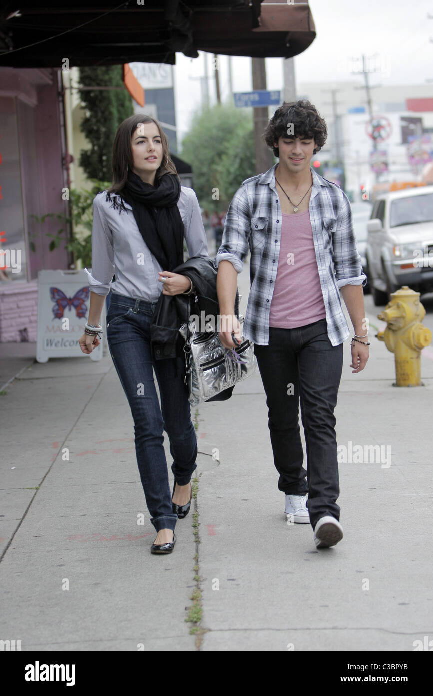 Joe Jonas of the Jonas Brothers and Camilla Belle walking down the