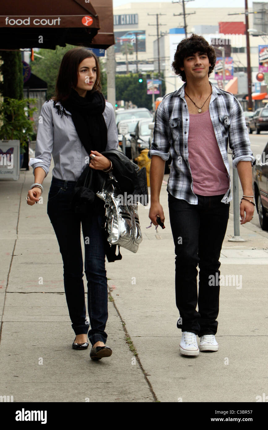 Joe Jonas of the Jonas Brothers and Camilla Belle walking down the