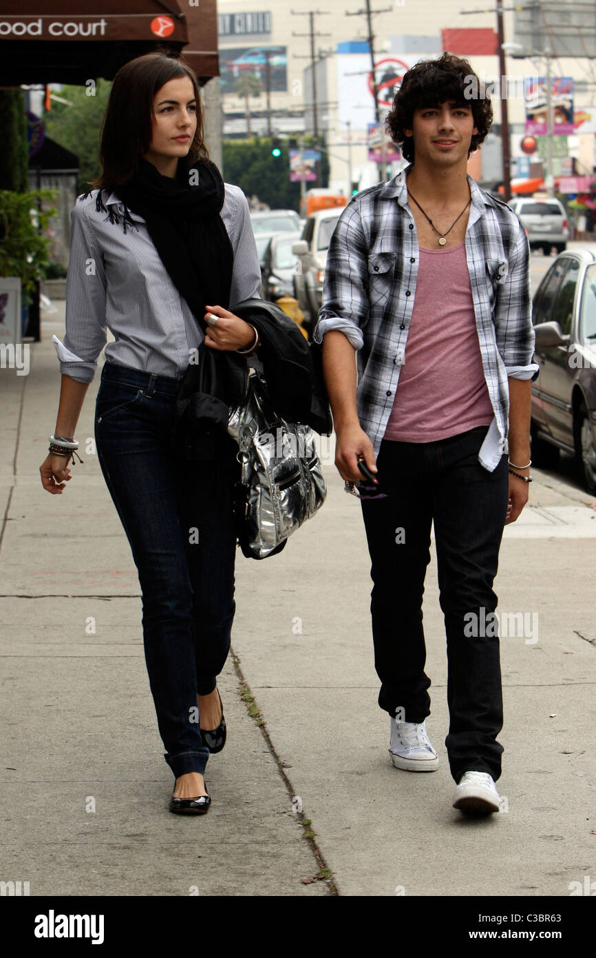 Joe Jonas of the Jonas Brothers and Camilla Belle walking down the