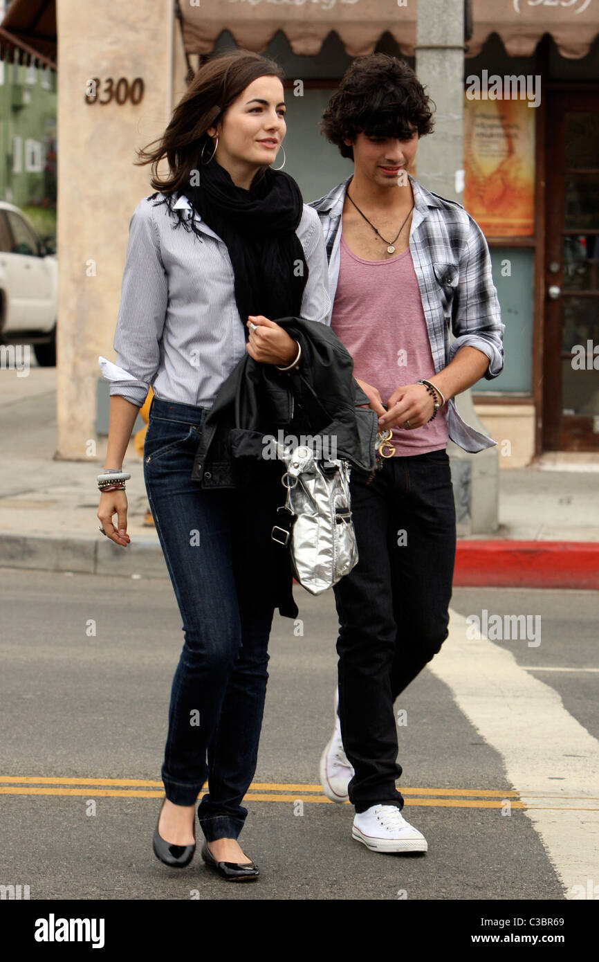 Joe Jonas of the Jonas Brothers and Camilla Belle walking down the