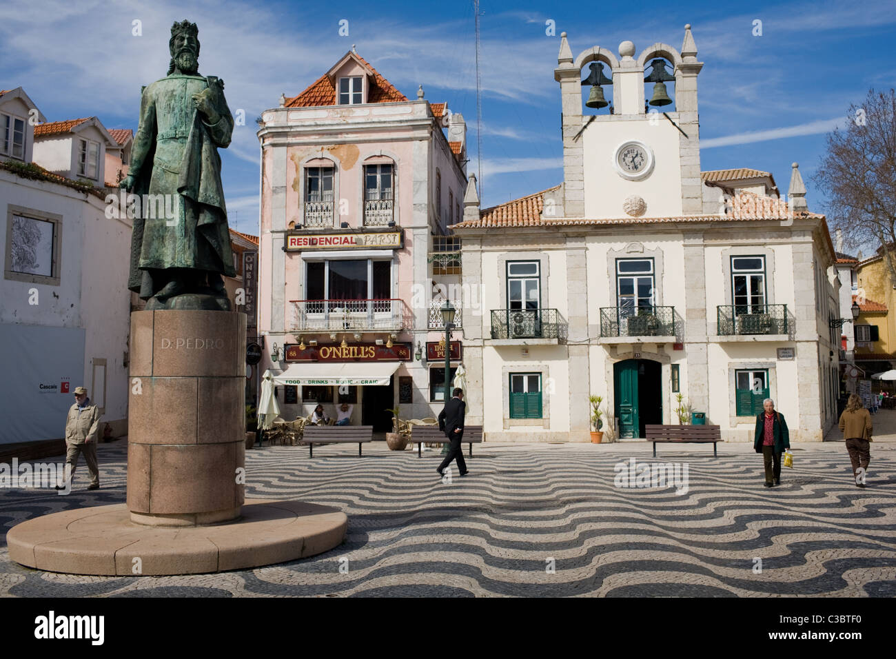 A plaza in Cascais, Portugal, with statue of monarch Dom Pedro I. Stock Photo