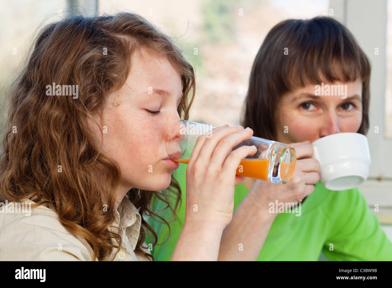 Daughter and her mom having a breakfast together Stock Photo