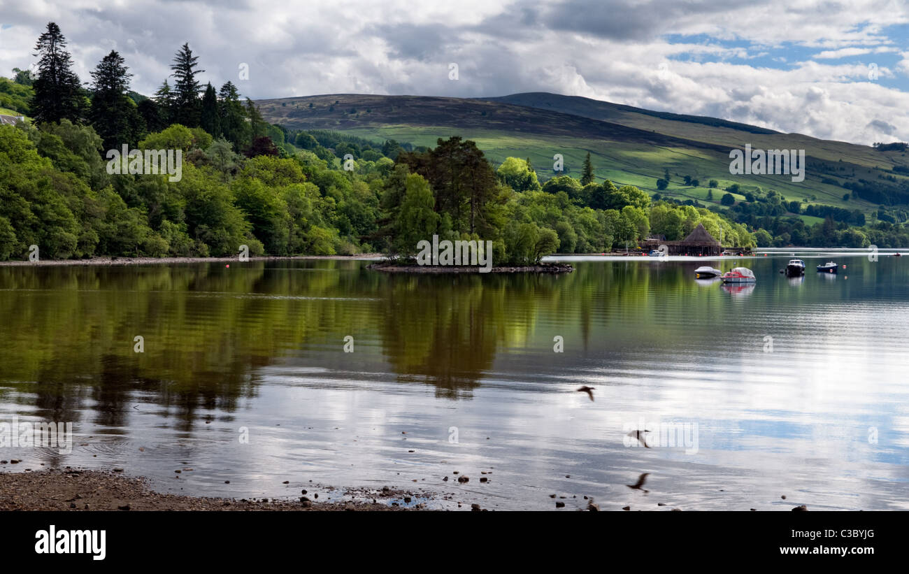 Panoramic of Loch Tay with reflection looking towards the Crannog at Kenmore, taken at Kenmore, Tayside, Scotland Stock Photo