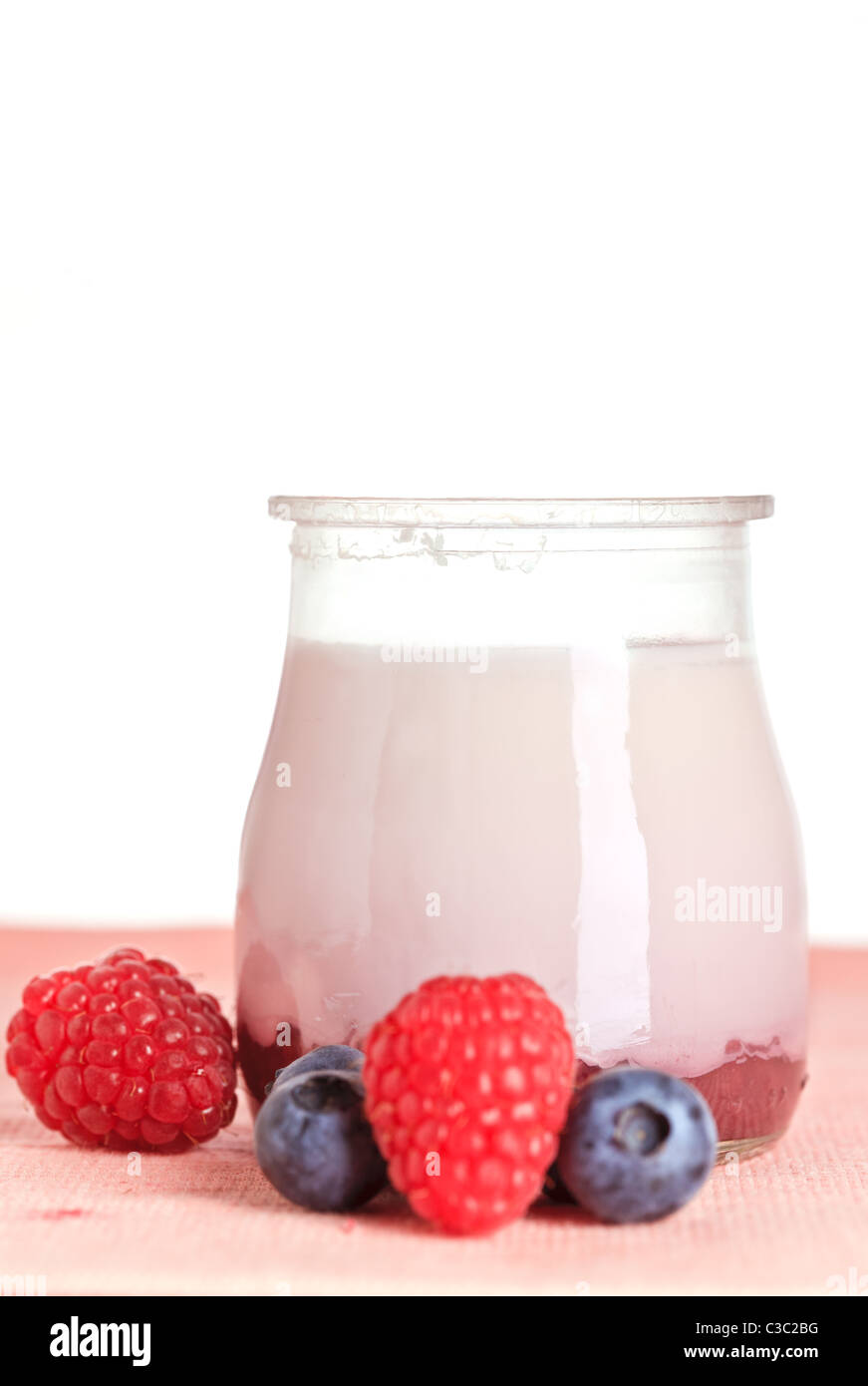 Delicious glass yogurt and fresh raspberry and blueberry. Shallow depth of field Stock Photo
