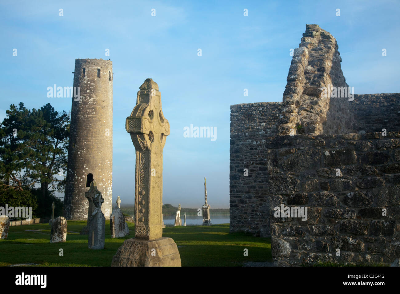 O'Rourke's Round Tower and the South Cross, Clonmacnoise Monastery, County Offaly, Ireland. Stock Photo