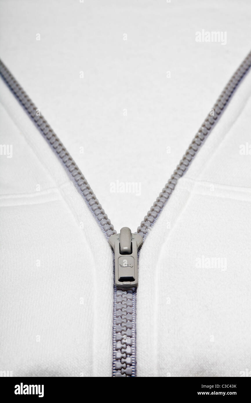 high-key photo of partially unzipped zipper in white sweatshirt Stock Photo