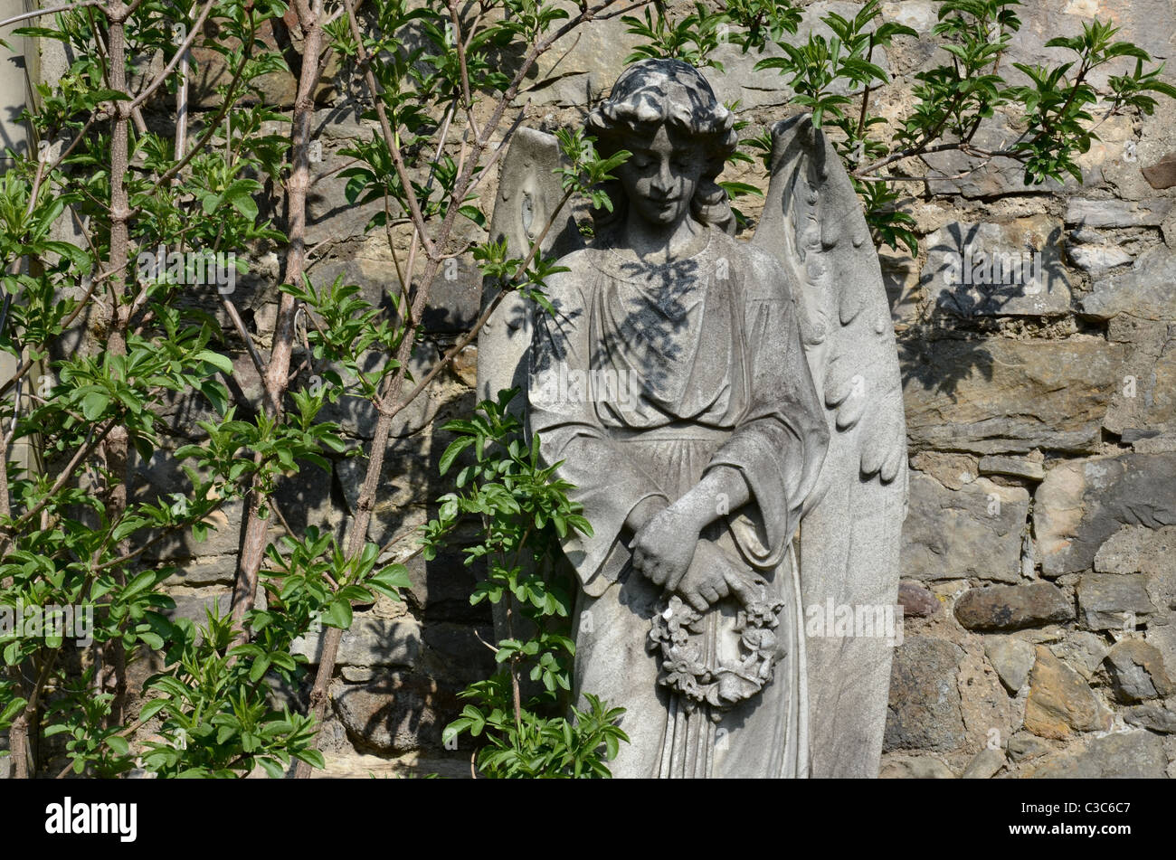 Statue of an angel holding a wreath in the Dean Cemetery Edinburgh, Scotland. Stock Photo