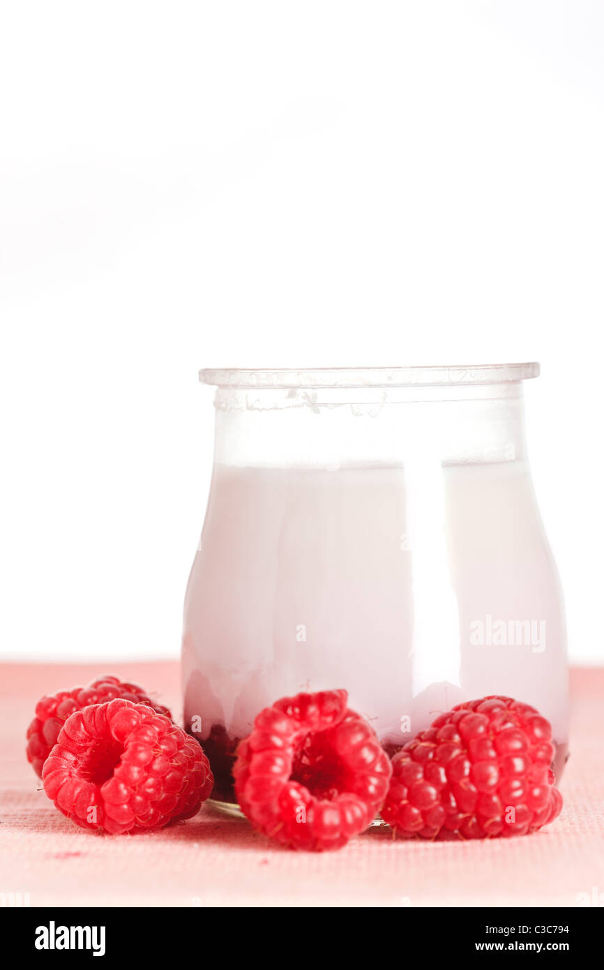 Delicious glass yogurt and fresh raspberries. Shallow depth of field Stock Photo