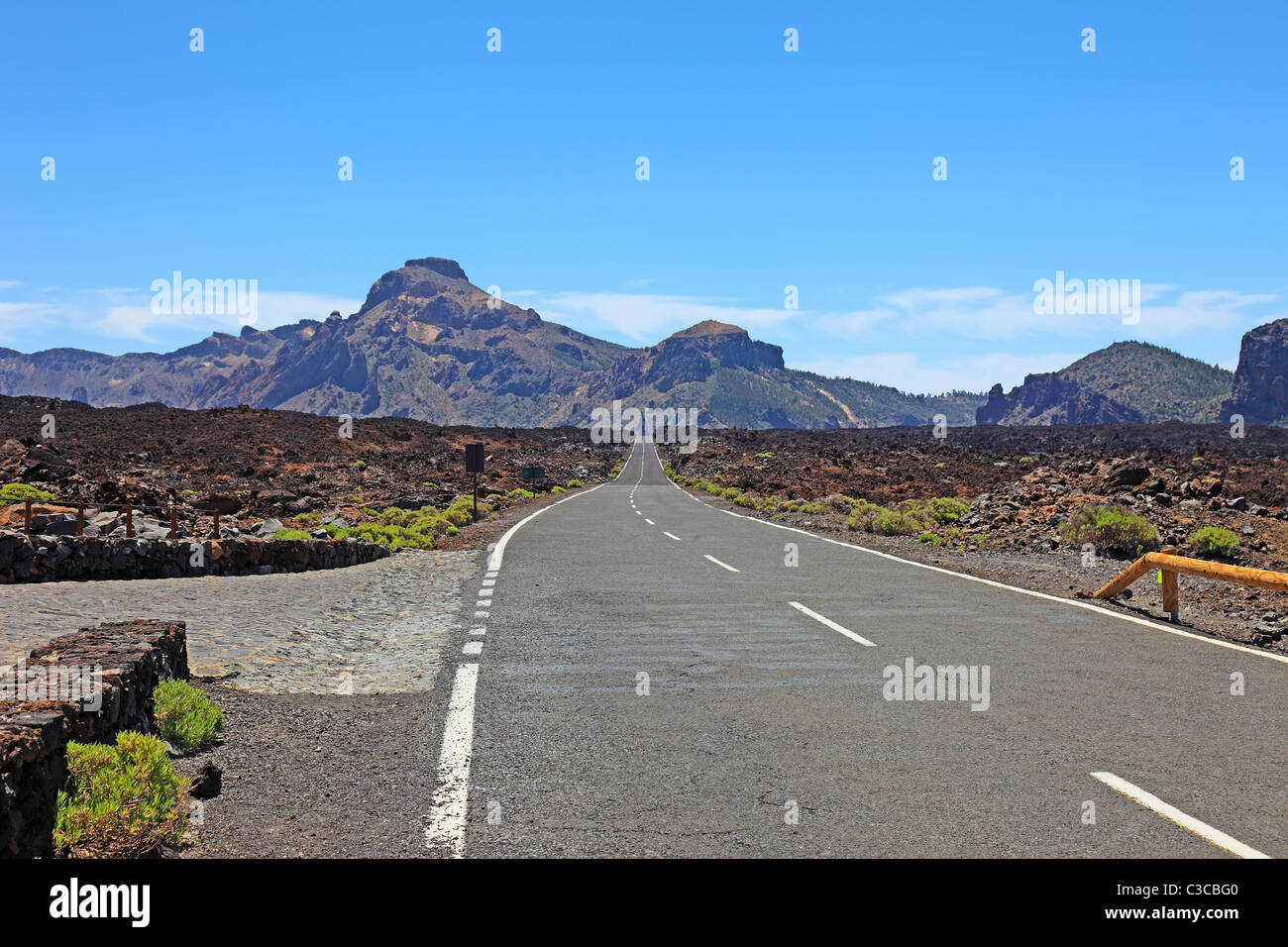 Desert highway road asphalt, journey horizon. Driving trip, straight empty lane. Freeway long path distant ahead. Lonely way discovery Tenerife, Spain Stock Photo