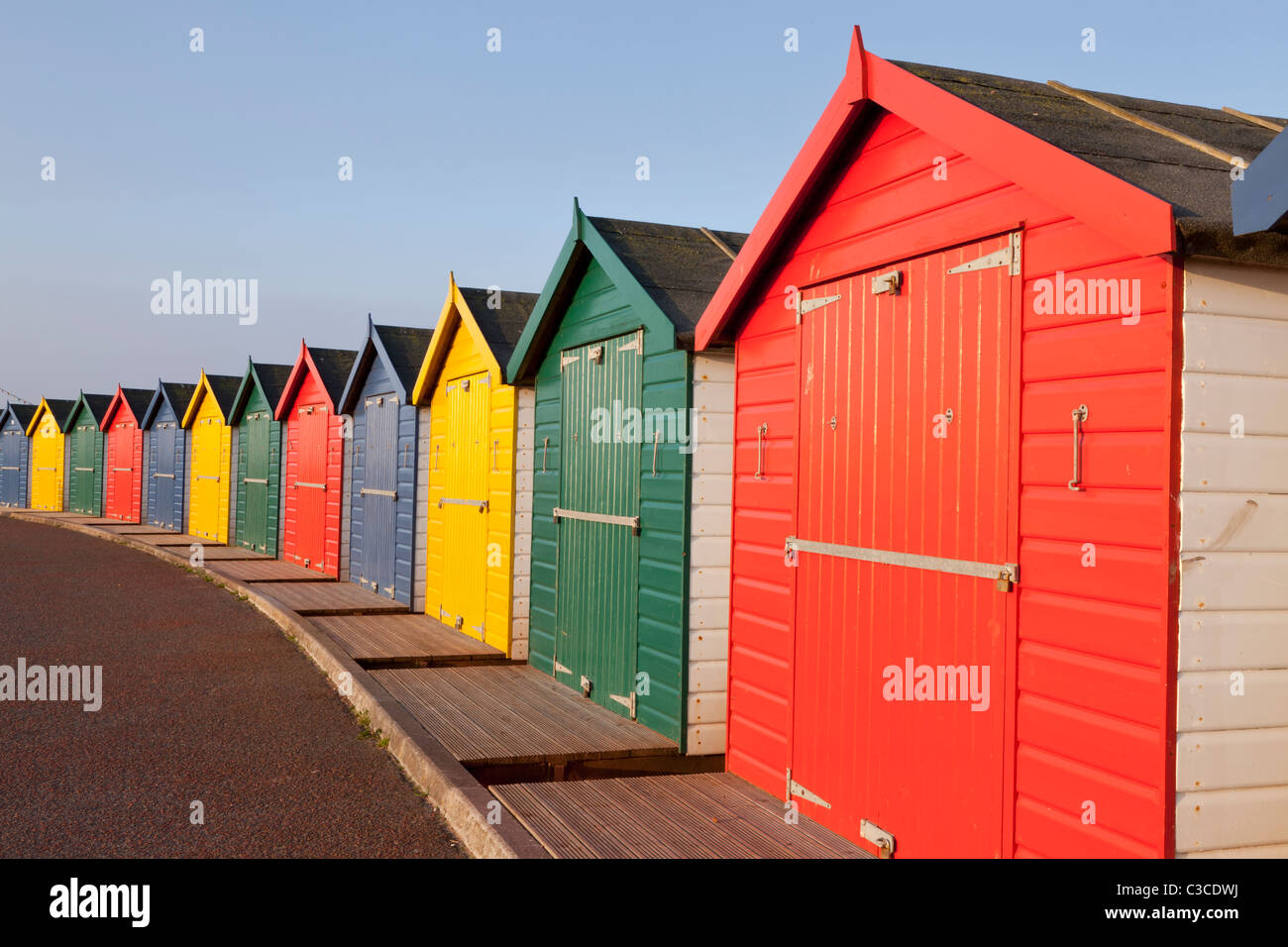 Arc of brightly coloured beach huts at Dawlish Warren, Devon Stock Photo