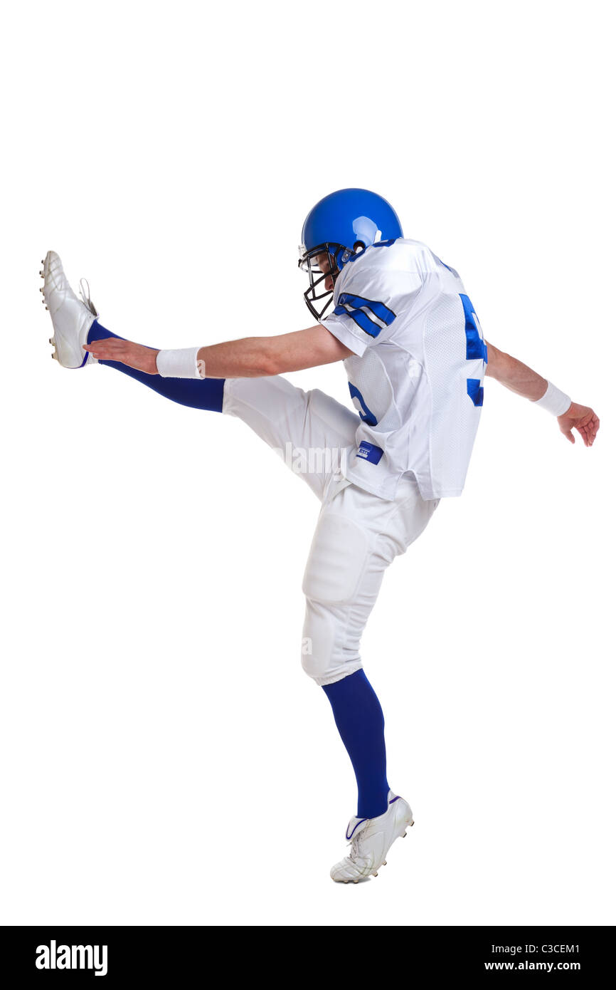 Photo of an American football player kicking, isolated on a white background. Stock Photo