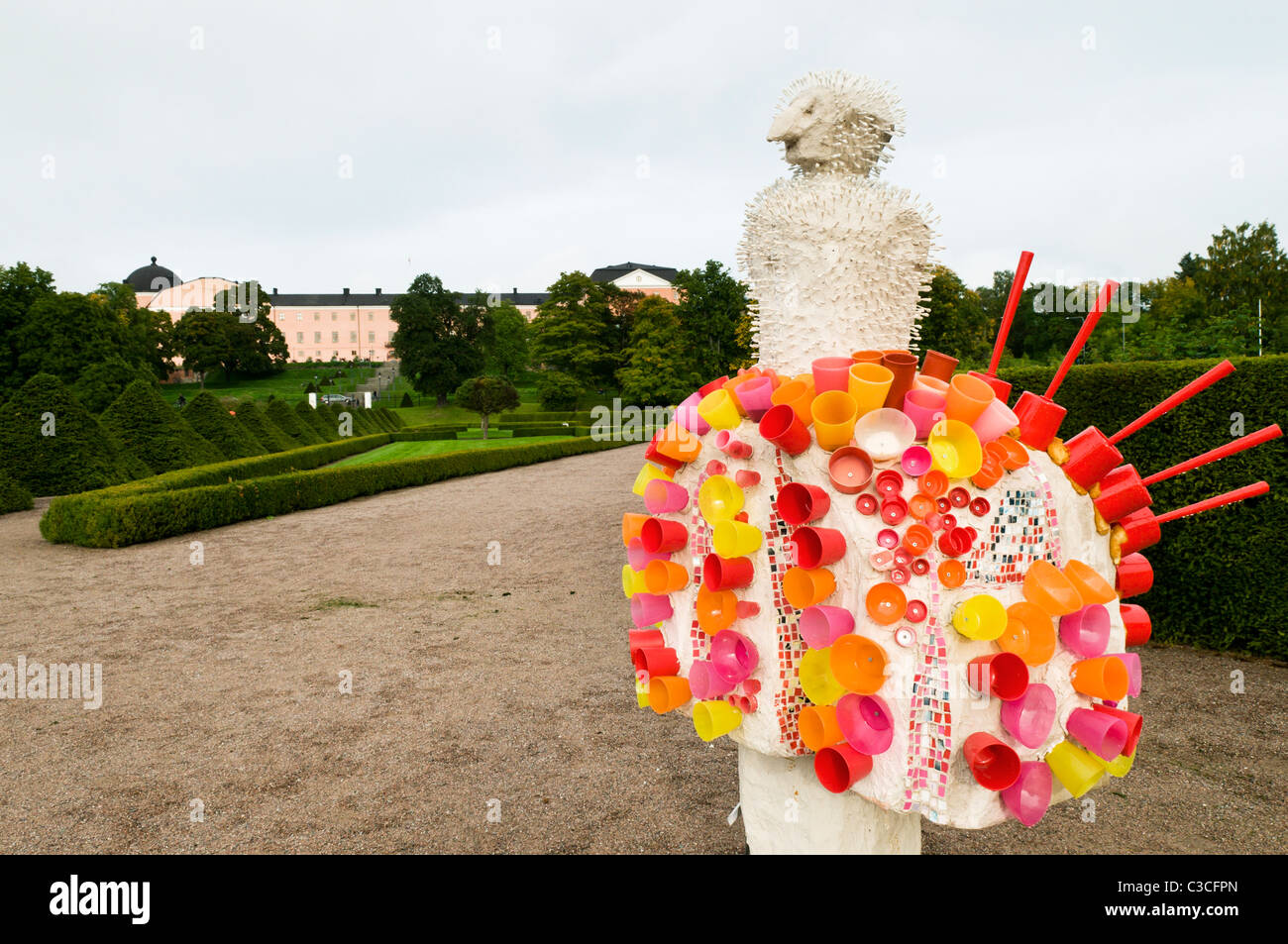 Bizarre sculpture in the Botanic Gardens and view of Uppsala Slott in Sweden. Stock Photo