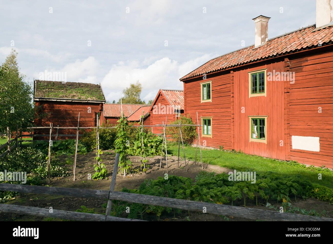 Old farm buildings and a kitchen garden at Disagården museum village in Gamla Uppsala, Sweden Stock Photo
