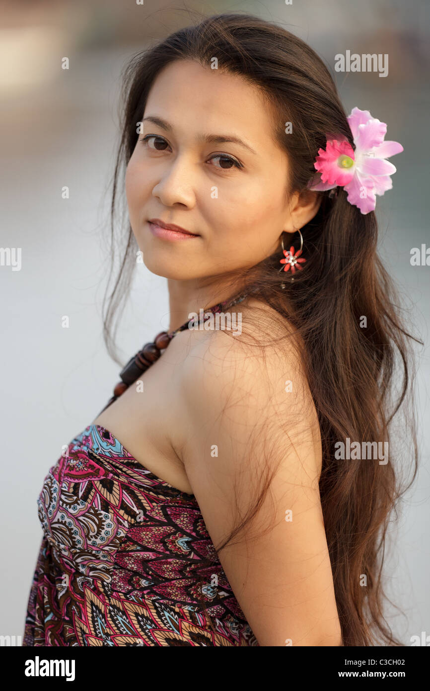 beautiful young thai woman outdoor portrait in dusk sunlight Stock Photo