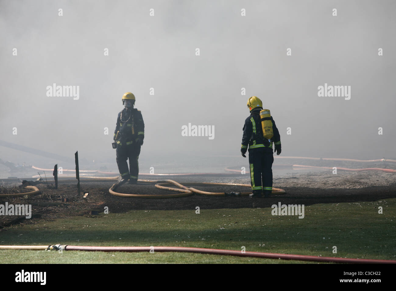 firefighters wearing breathing apparatus Stock Photo