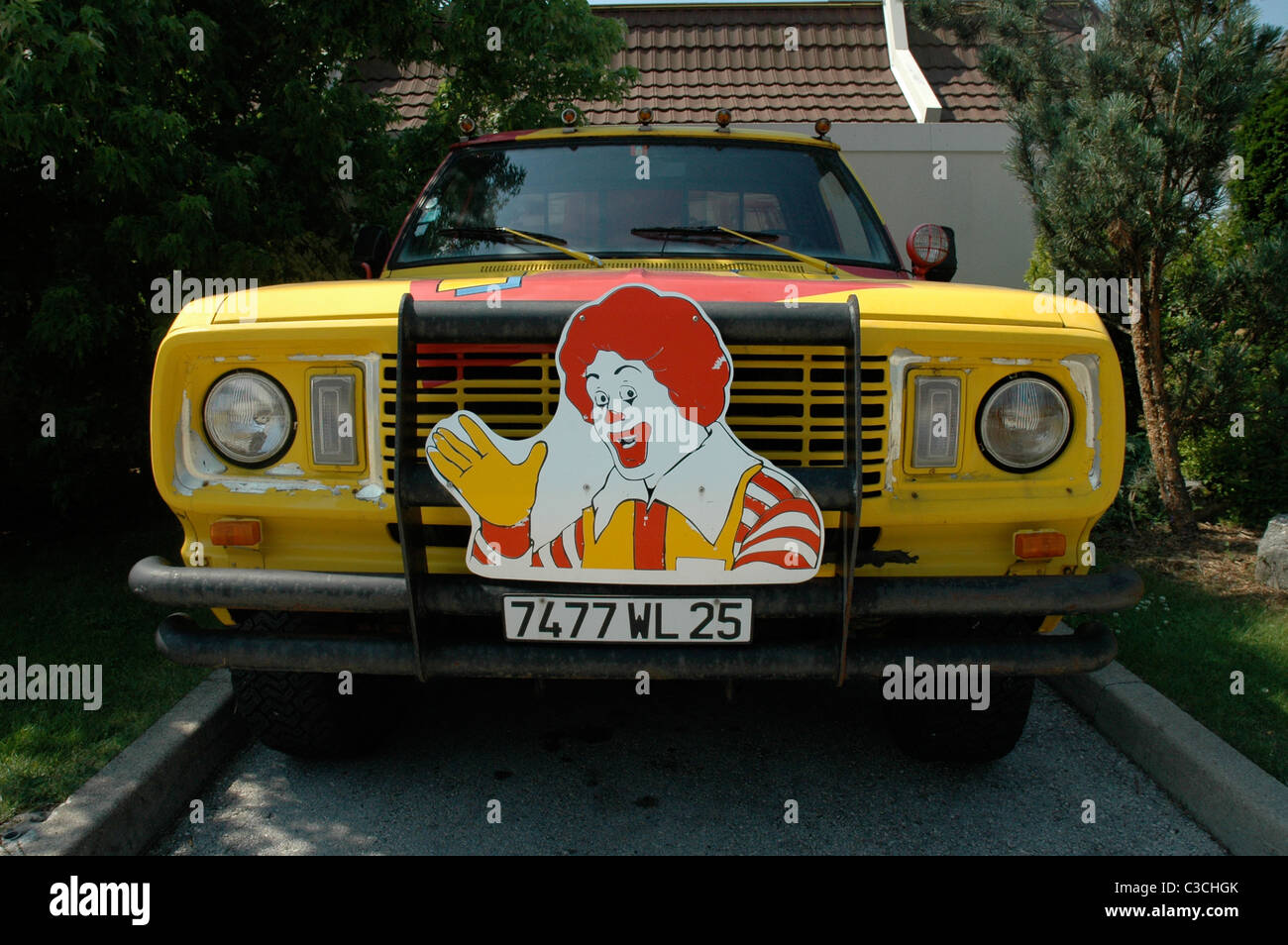 American truck with Ronald McDonald picture strapped to the front, parked near a Mc Donalds restaurant in Pontarlier, France. Stock Photo