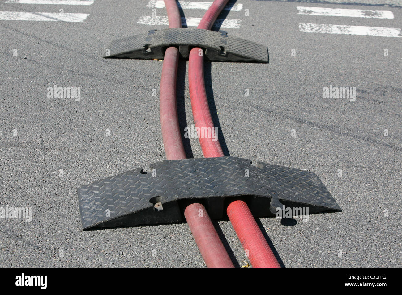 ramps put in place by firefighters to protect there hoses from traffic  Stock Photo - Alamy