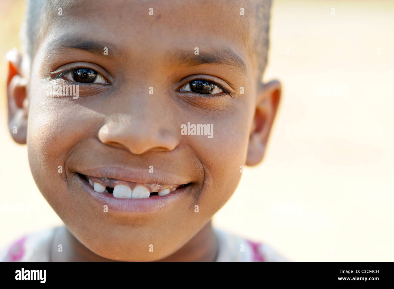 This young Indian girl has some missing teeth, but big beautiful eyes and smile. Stock Photo