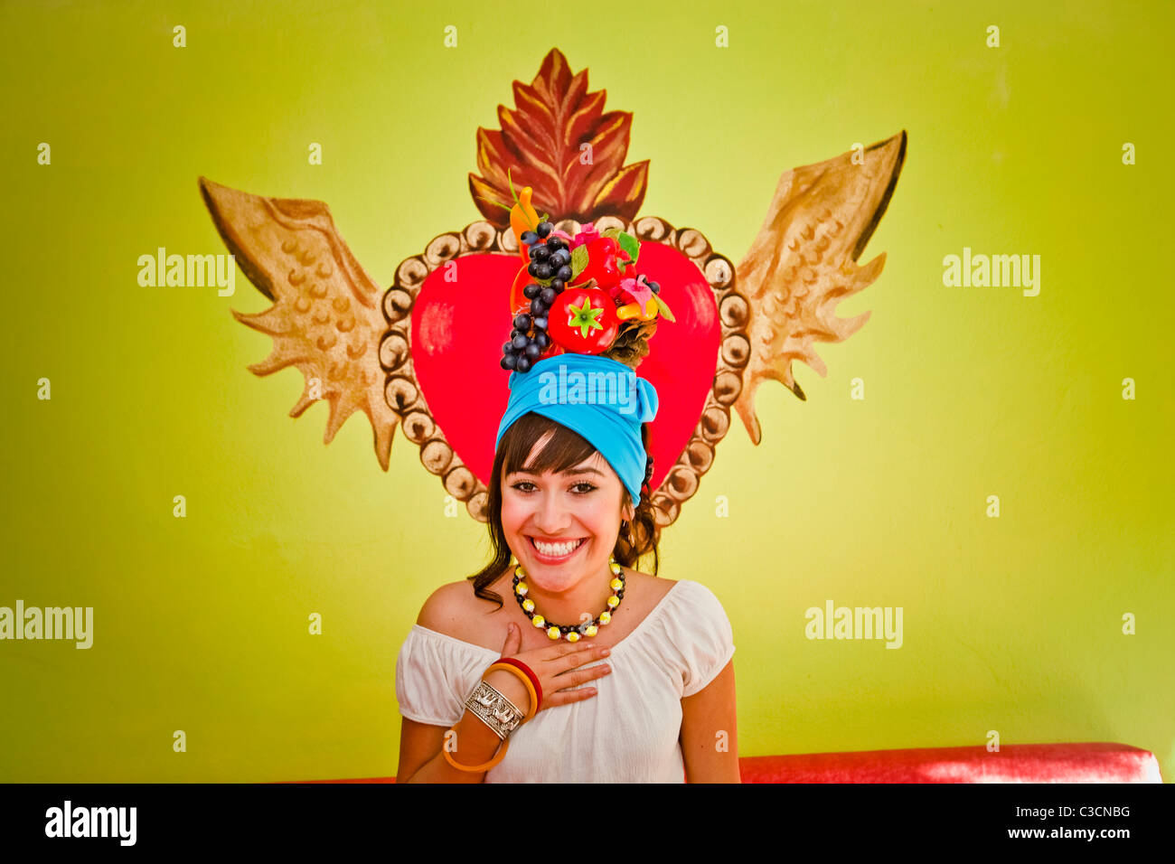 young woman wearing fruit hat Stock Photo Alamy