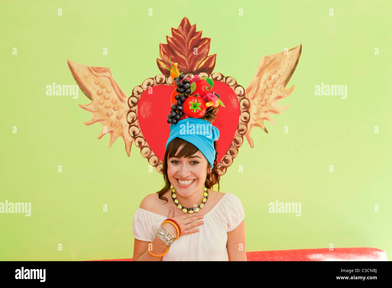 young woman wearing fruit hat Stock Photo Alamy