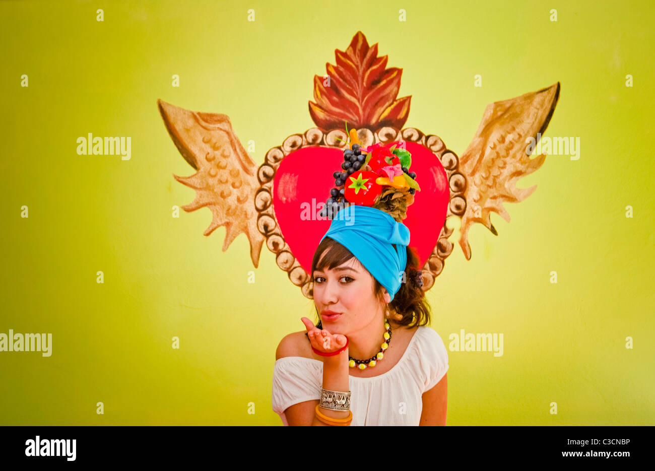 young woman wearing fruit hat Stock Photo Alamy