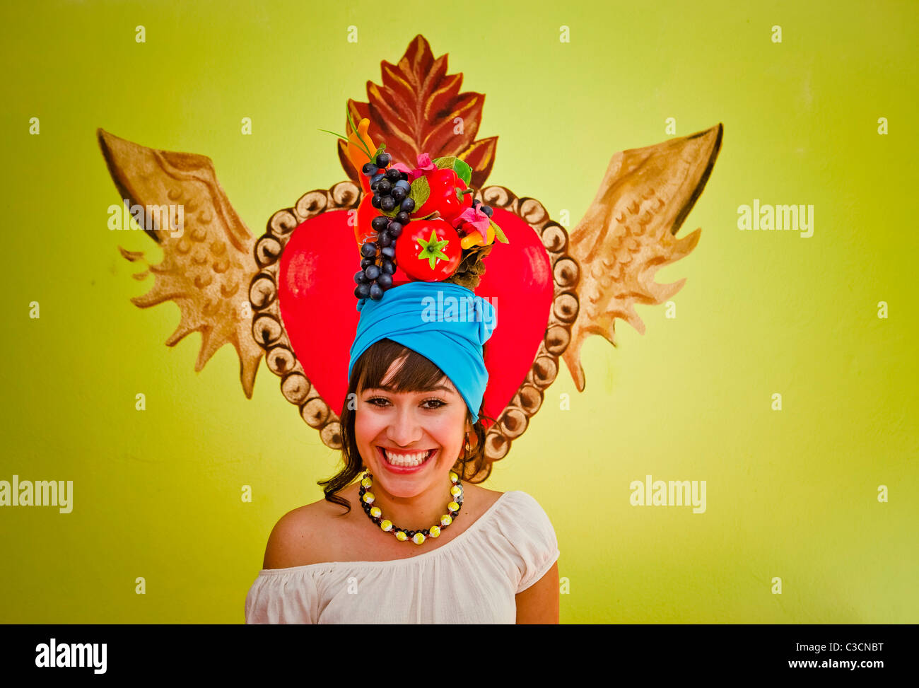 young woman wearing fruit hat Stock Photo Alamy
