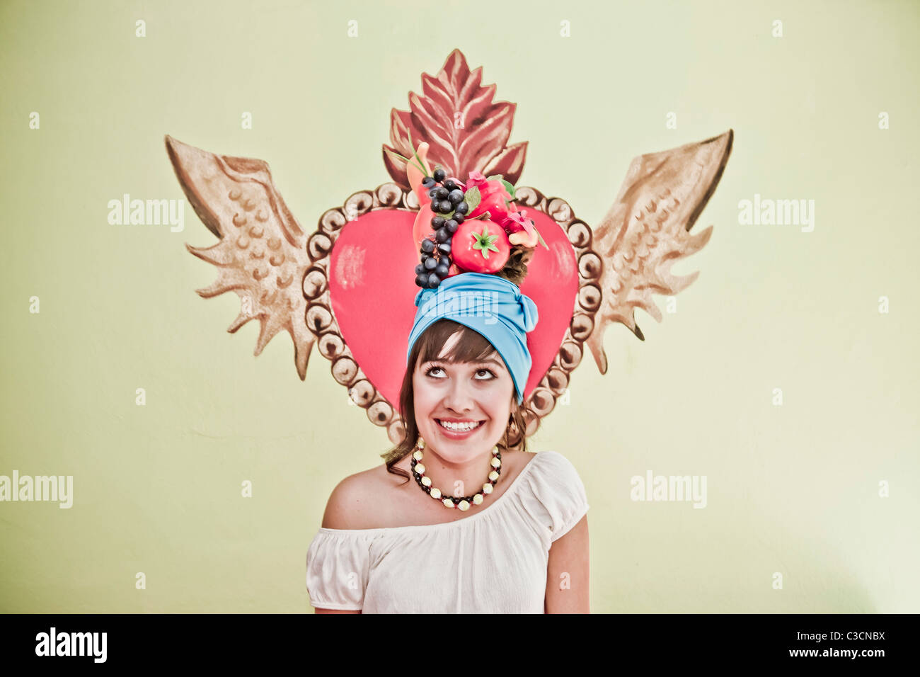 young woman wearing fruit hat Stock Photo Alamy