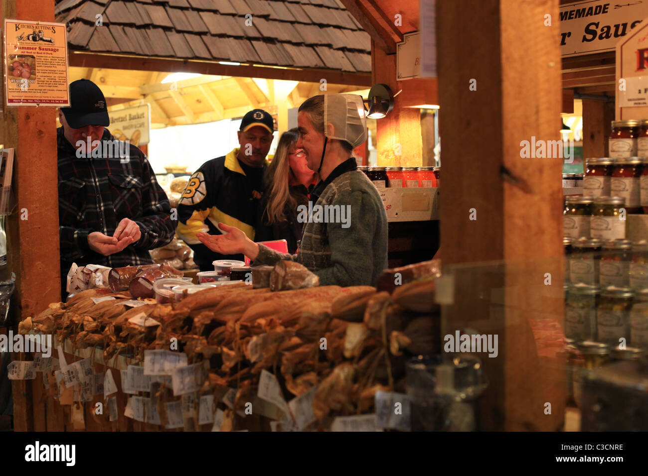 Amish woman selling sausage at St. Jacobs farmers' market in Ontario