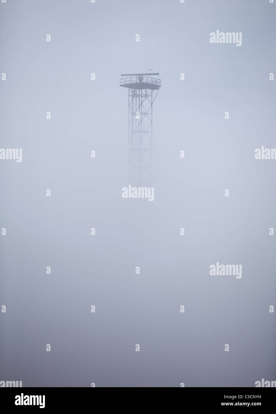 Radar antenna tower in heavy fog Stock Photo