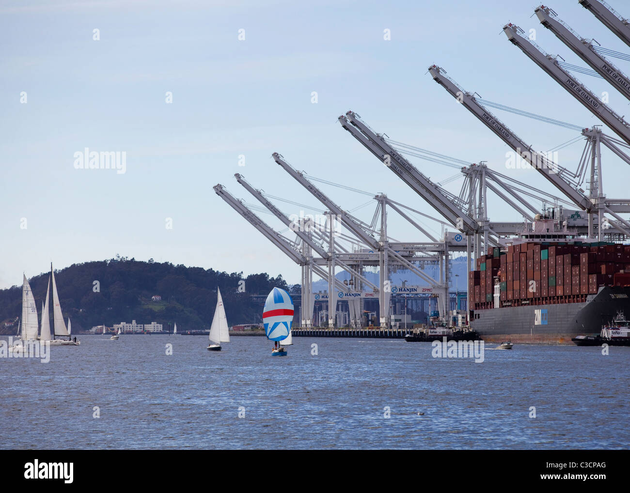 Sail boats and gantry cranes - Port of Oakland, California USA Stock Photo