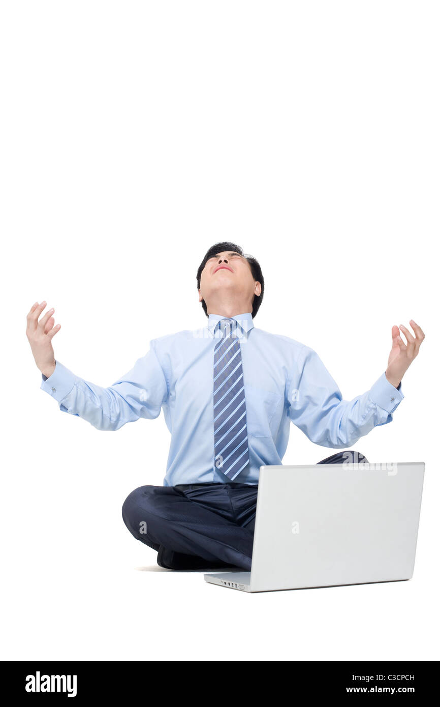 A frustrated businessman sitting on the floor with his laptop Stock ...