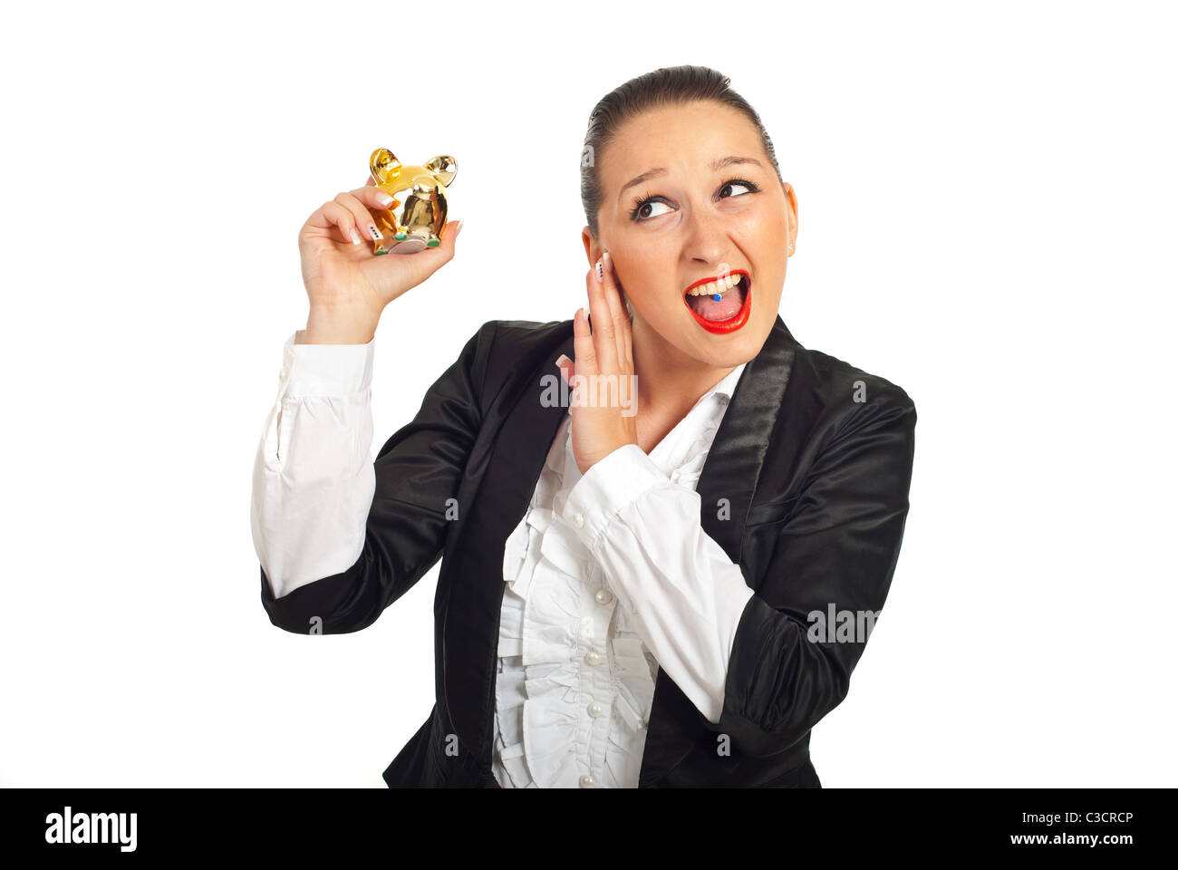 Cool business woman trying to hear the piggy bank sound isolated on