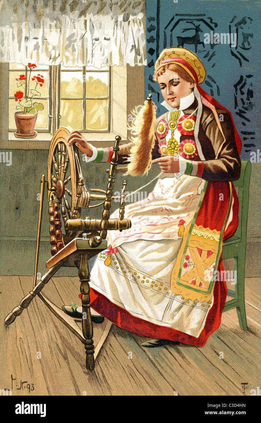 A woman in traditional Swedish costume working at a spinning wheel Stock Photo