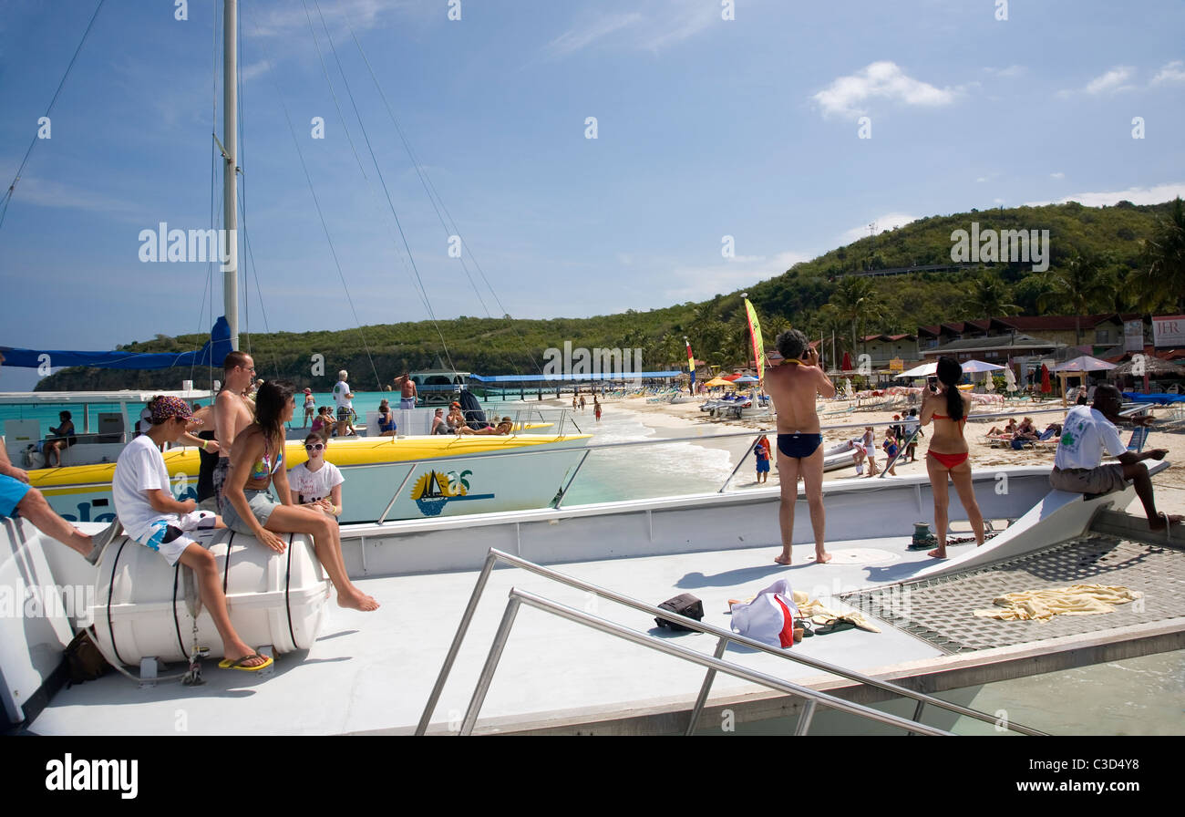 Antigua On board Catamaran picking up tourists on Dickenson Bay for excursion to Barbuda Stock Photo