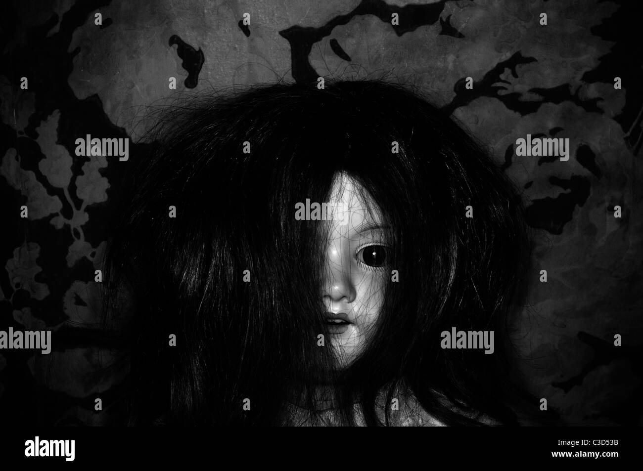 Ancient dark porcelain doll Stock Photo