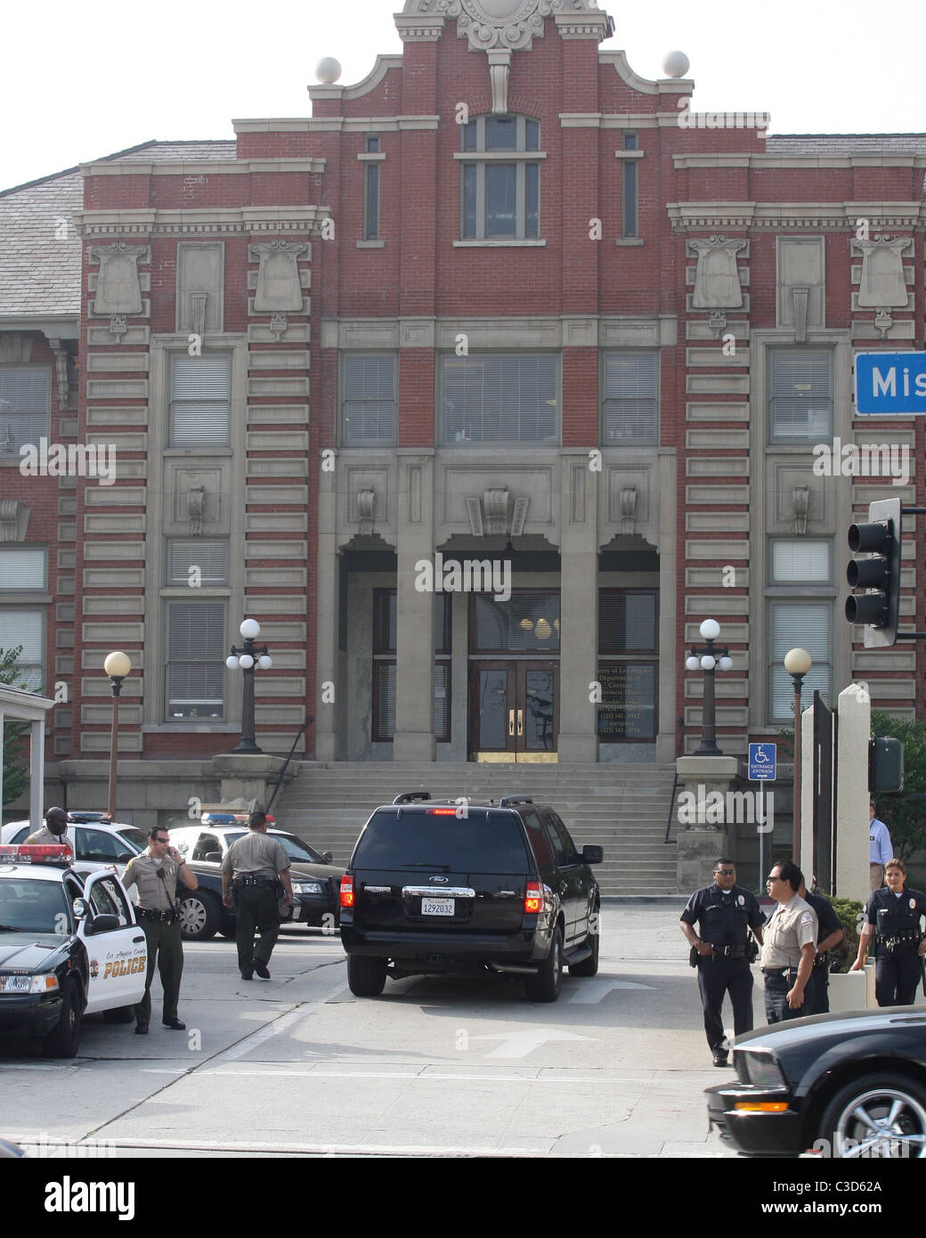 Crowds and media crews gather outside the Los Angeles County coroner's