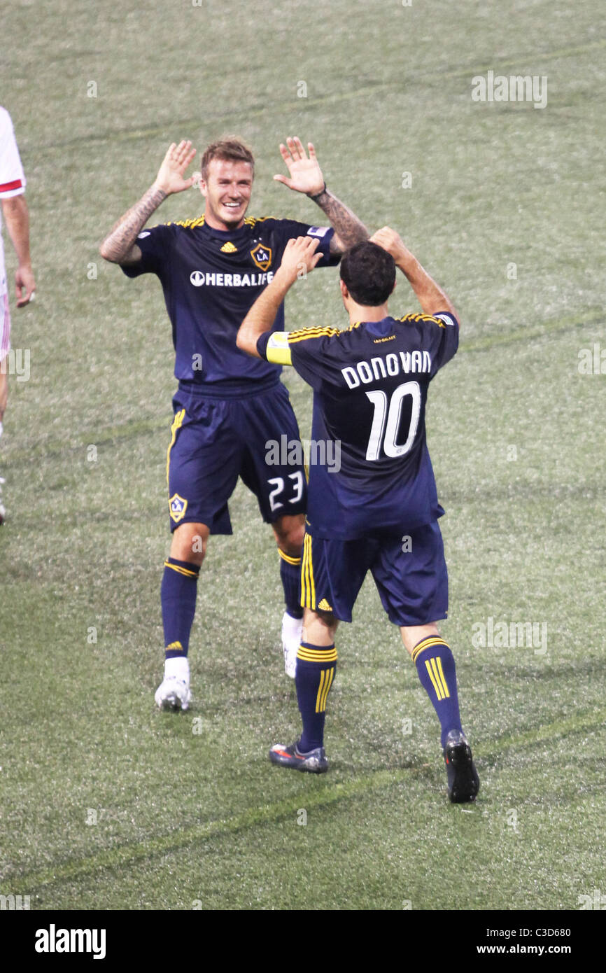 Landon Donovan #10 and David Beckham #23 of the LA Galaxy  celebrate a goal in the first half by teammate Eddie Lewis #6 during Stock Photo