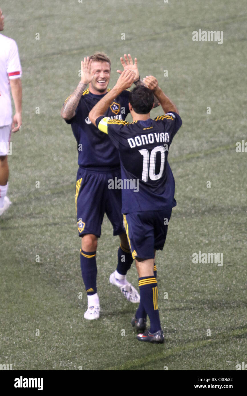 Landon Donovan #10 and David Beckham #23 of the LA Galaxy  celebrate a goal in the first half by teammate Eddie Lewis #6 during Stock Photo