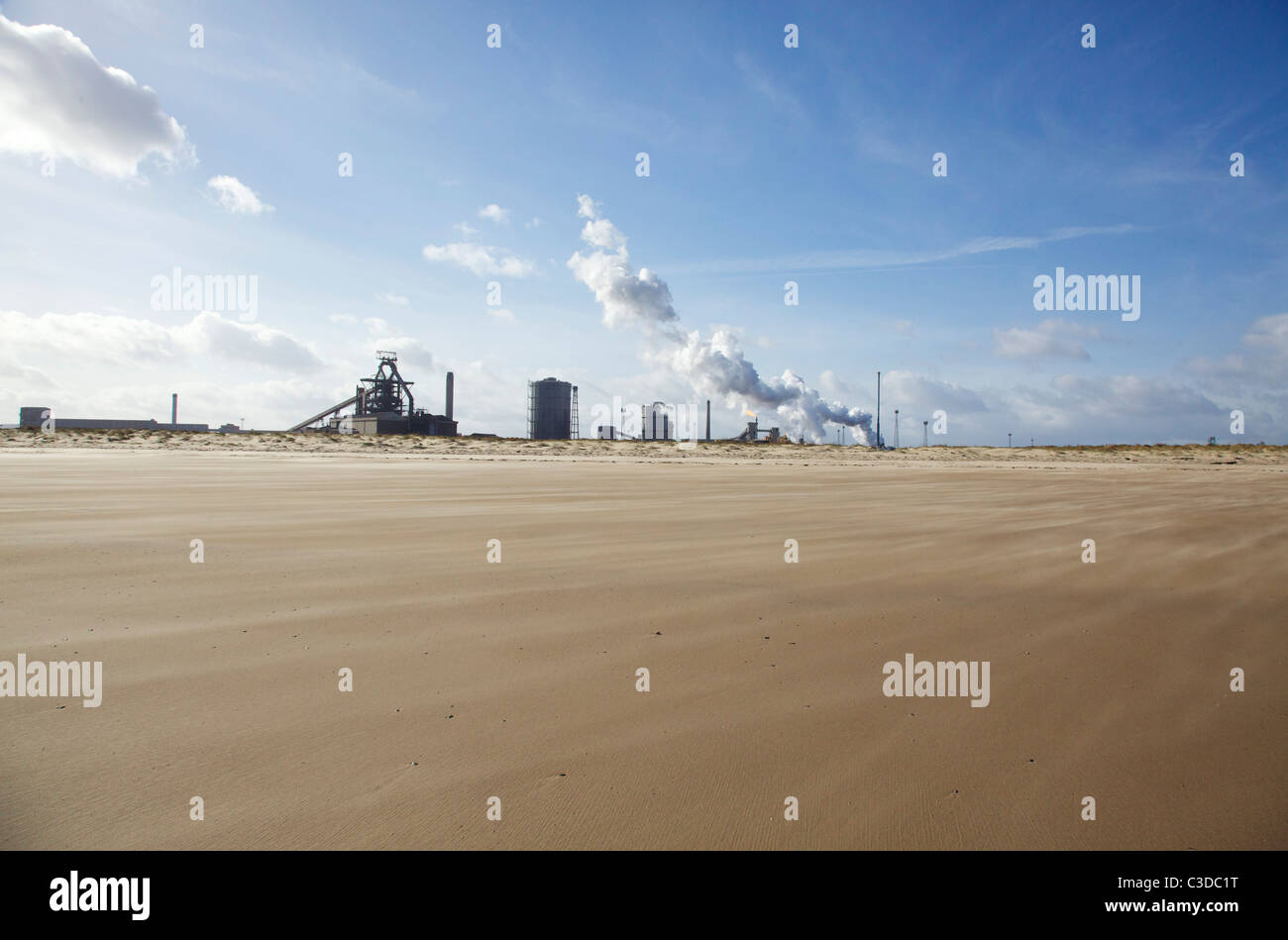 Redcar steelworks with wind blown sandy beach in foreground Stock Photo