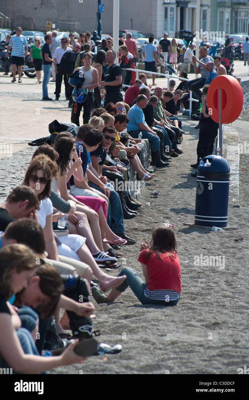Aberystwyth promenade full of sunbathers Stock Photo