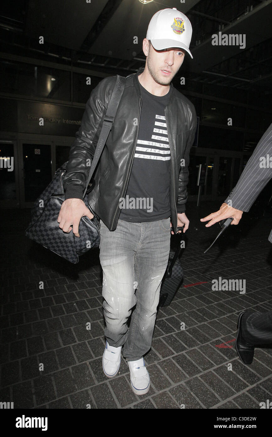 Justin Timberlake carrying his matching Louis Vuitton luggage as