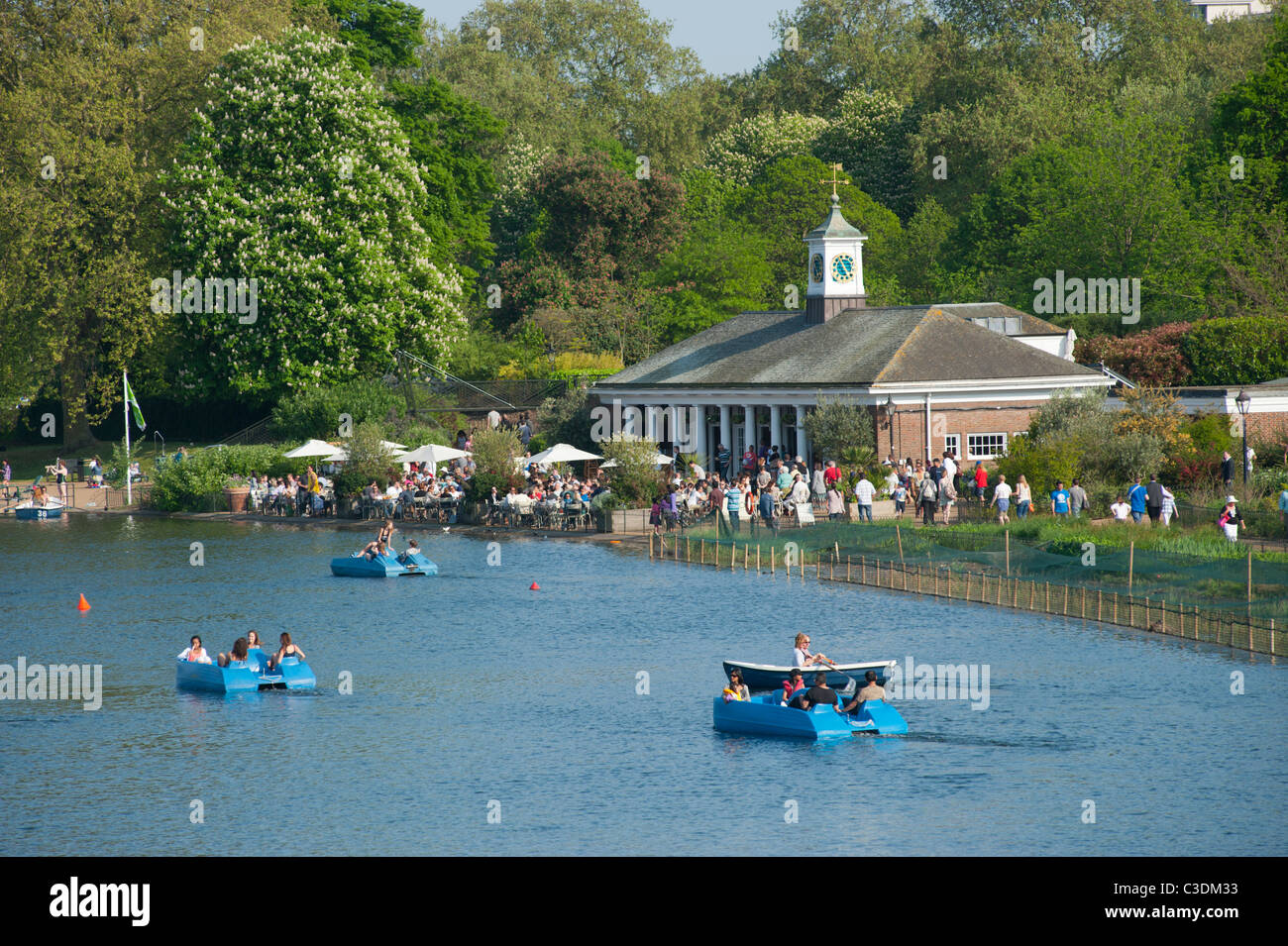 Pleasure boats on the Serpentine in Hyde Park, near the Lido cafe bar in London, England UK. Stock Photo