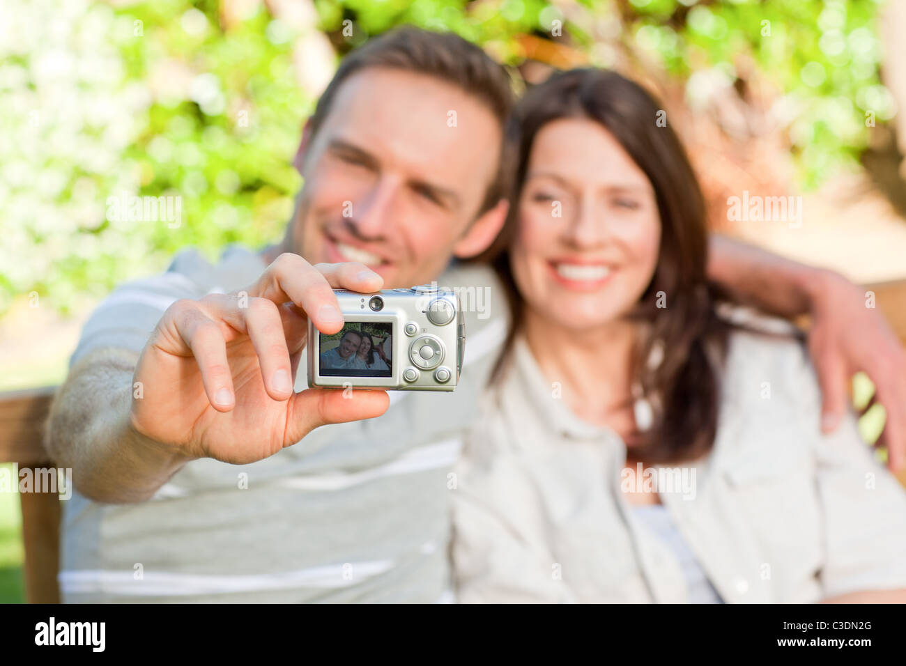 Lovers taking a photo of themselves in the garden Stock Photo - Alamy