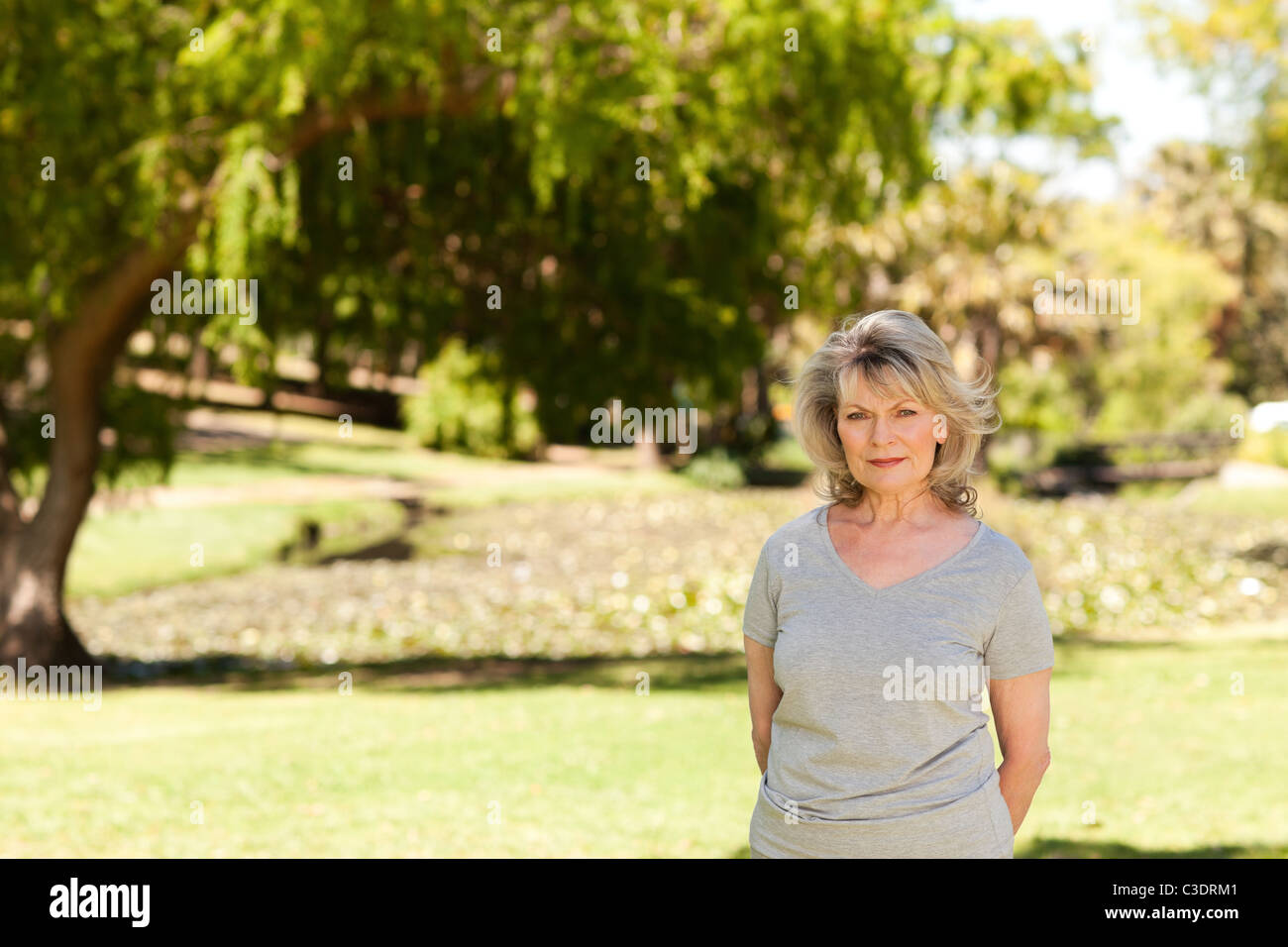 Portrait of a senior woman in the park Stock Photo - Alamy